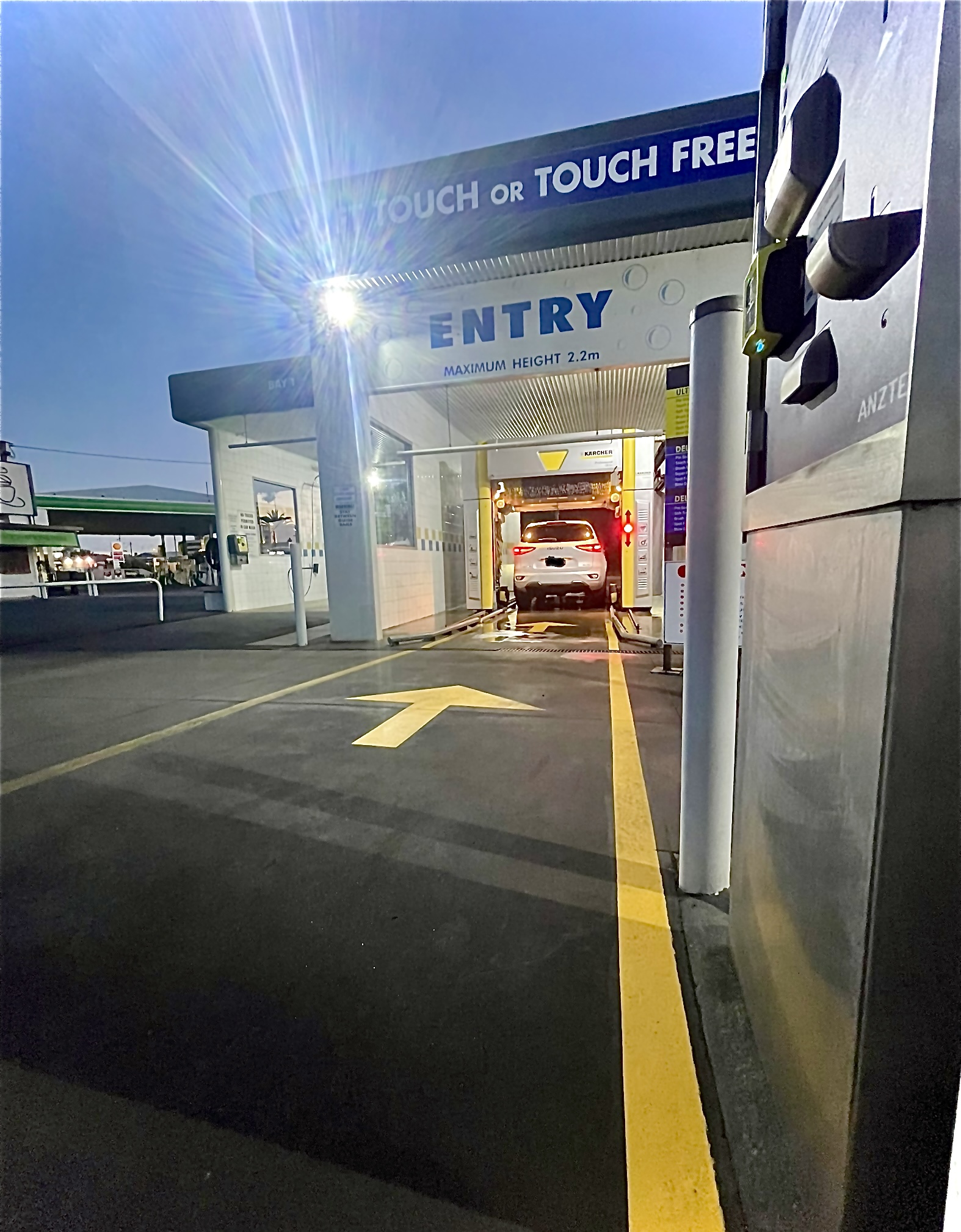 The lit entry to the Swift Car Wash automatic bay at dusk