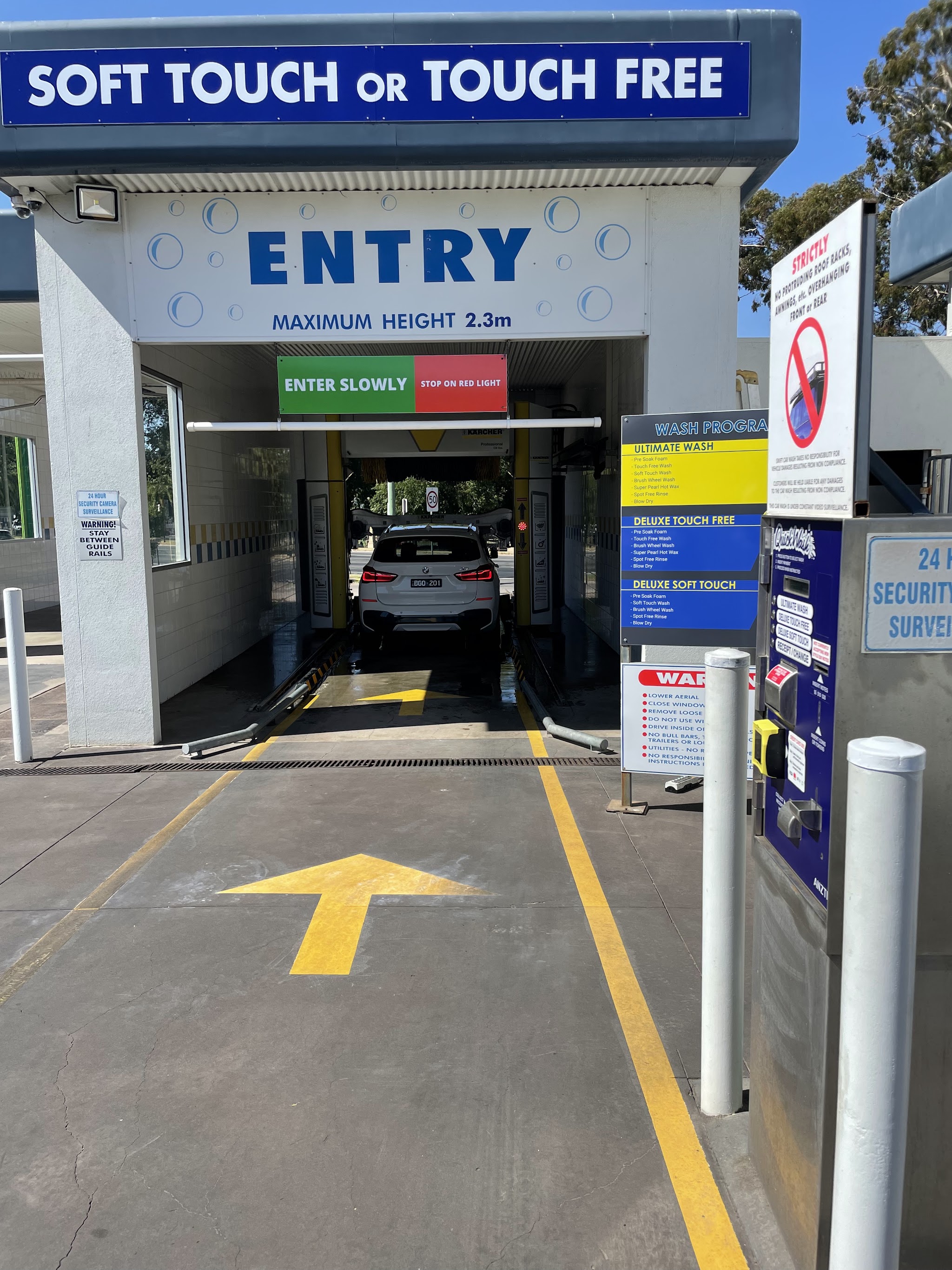 The entry to the automatic bay with the wash program board beside it